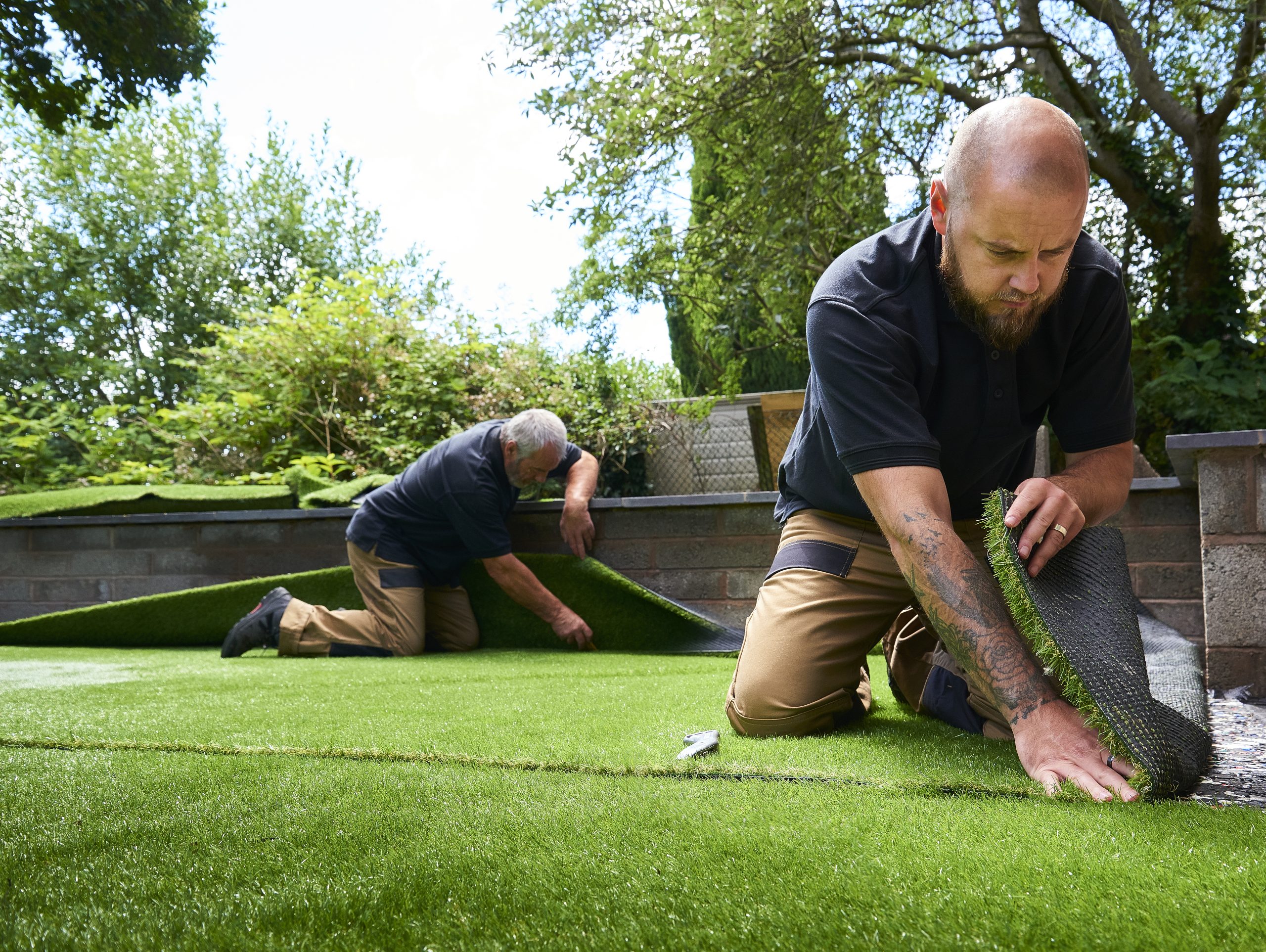 Laying artificial grass synlawn turf to increase business curb appeal